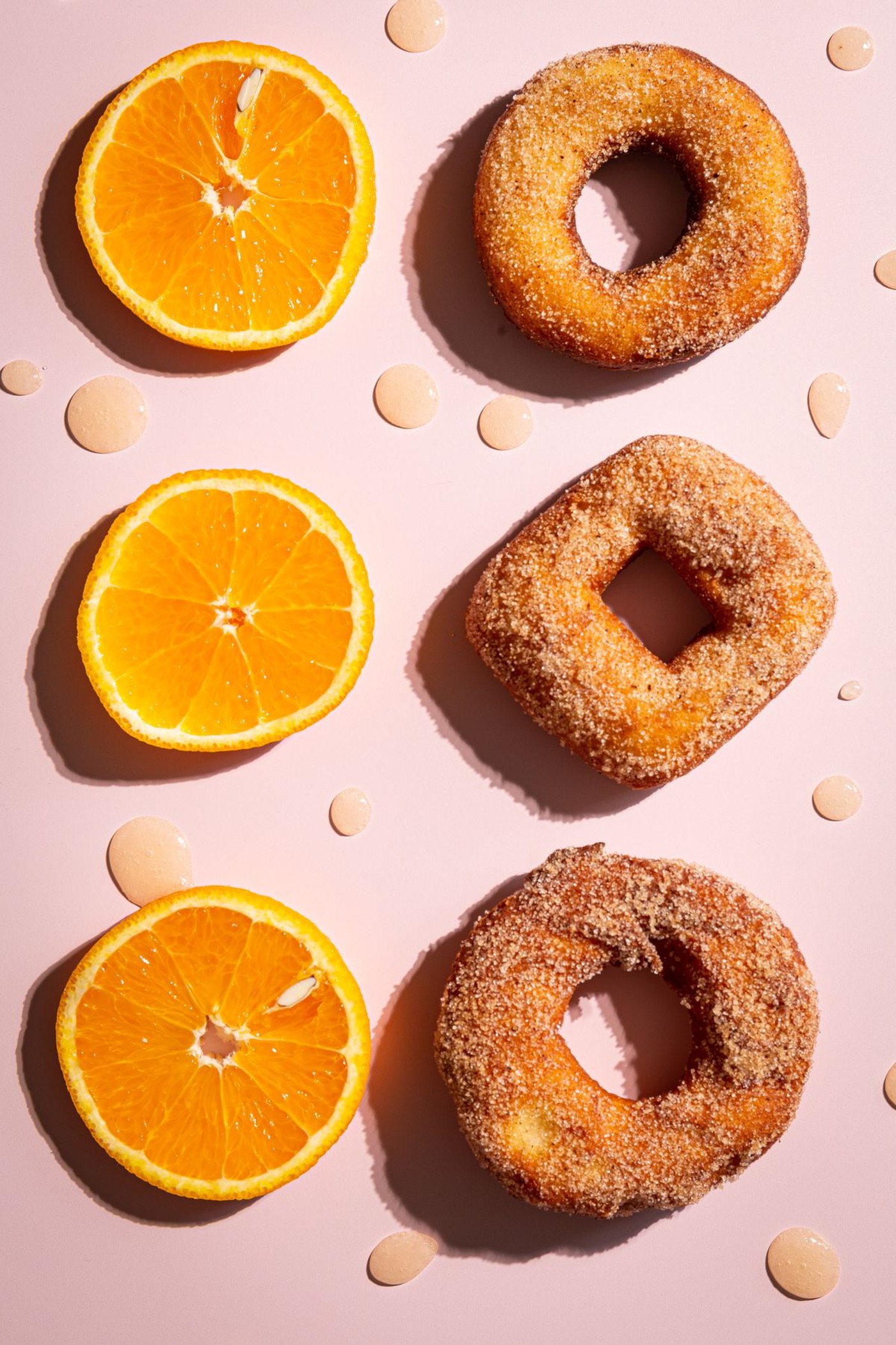 Baked cinnamon sugar donuts arranged on a plate with a cinnamon coating