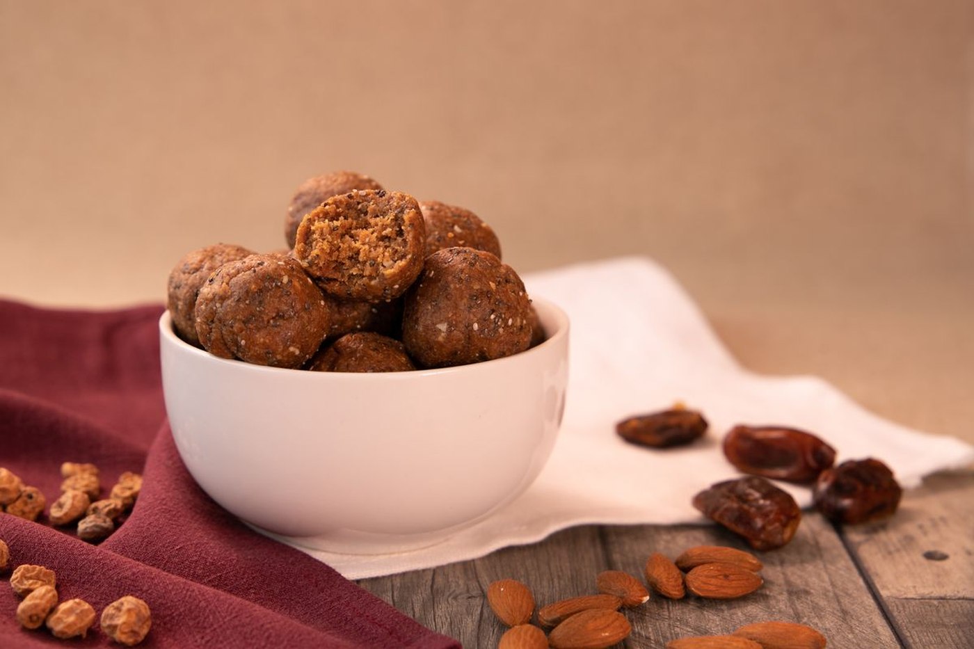 Coconut almond energy bites rolled in shredded coconut on a plate