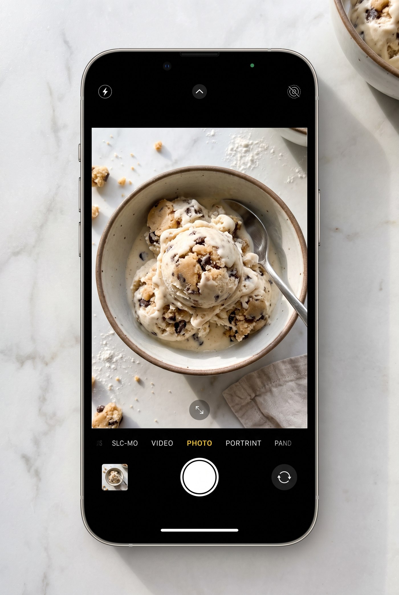 A bowl of protein soft serve swirled with cookie dough bits