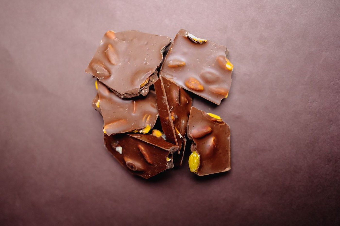 Broken pieces of dark chocolate almond bark topped with sea salt